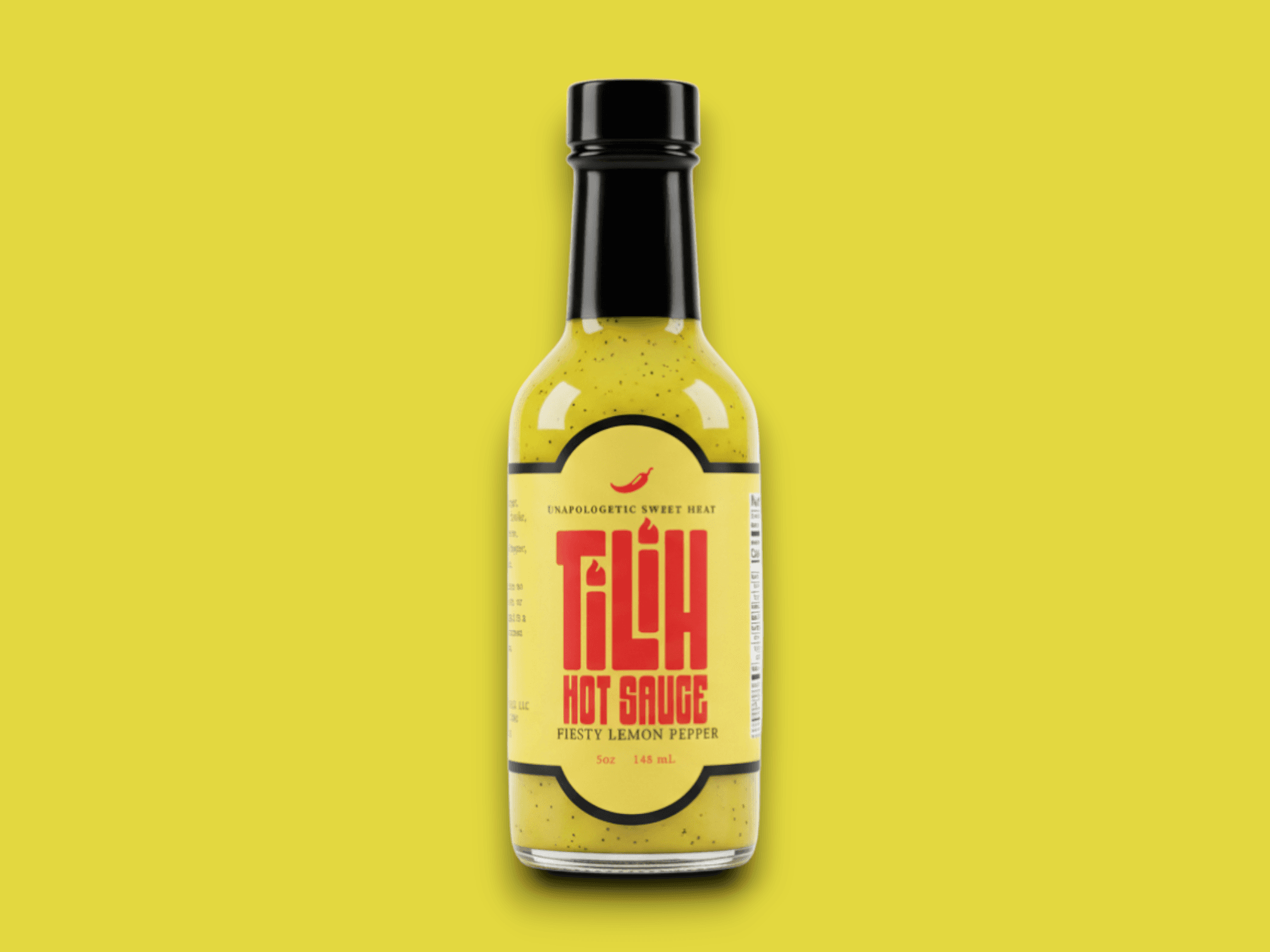 Close-up of Lemon Pepper Hot Sauce bottle on yellow background